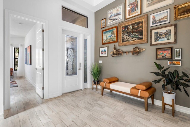 foyer with baseboards and light wood finished floors