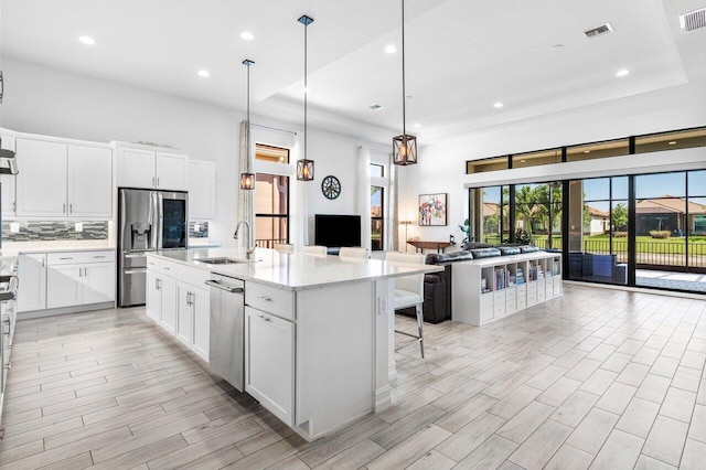 kitchen with stainless steel appliances, visible vents, a sink, and recessed lighting