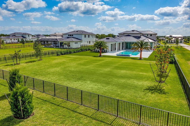 view of yard featuring a fenced in pool, a fenced backyard, a patio area, and a residential view