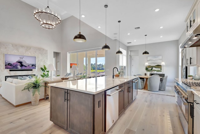 kitchen featuring open floor plan, appliances with stainless steel finishes, and a sink
