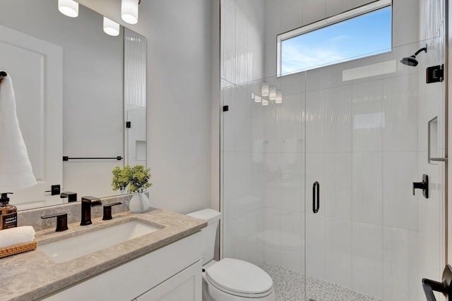 full bathroom with vanity, toilet, and a stall shower