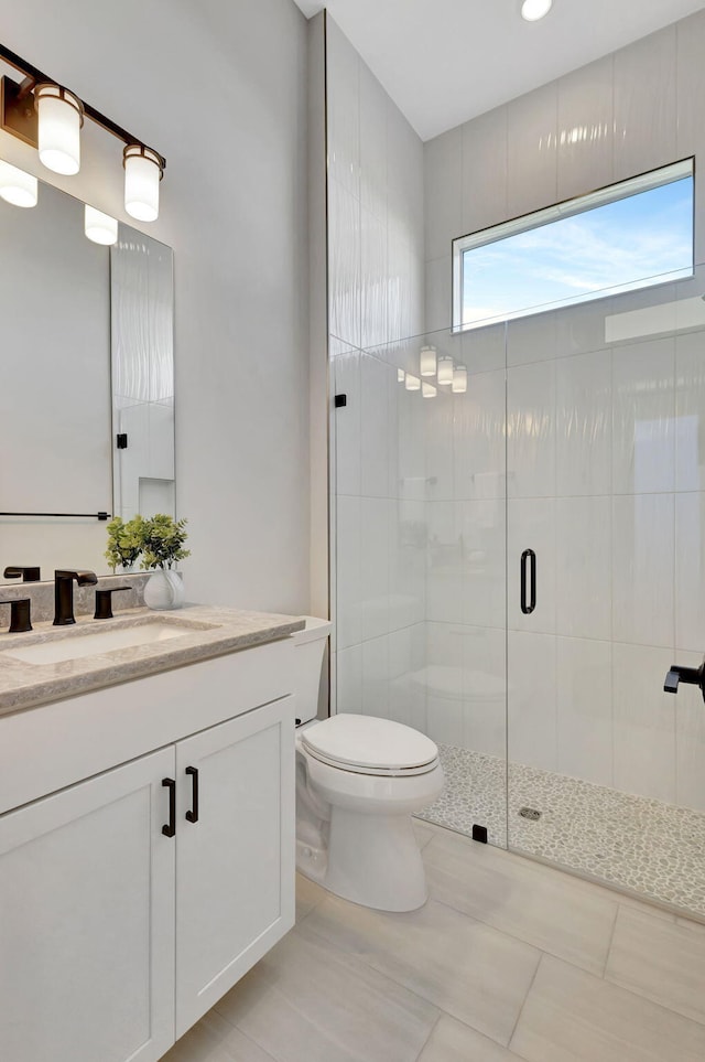 full bath featuring vanity, tile patterned flooring, a shower stall, and toilet