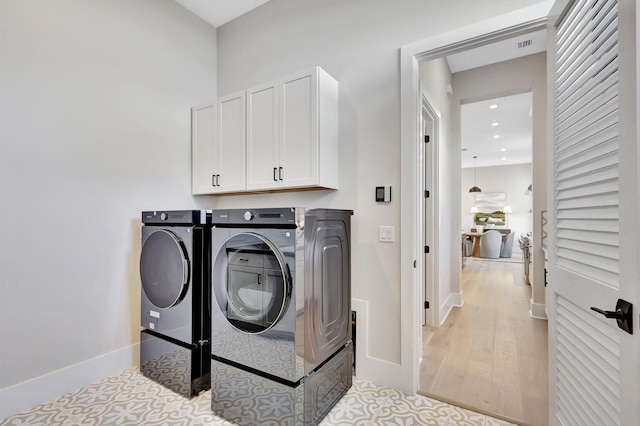 laundry room with visible vents, washer and dryer, baseboards, recessed lighting, and cabinet space