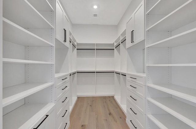 walk in closet with light wood-style flooring and visible vents