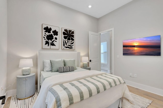bedroom featuring baseboards, recessed lighting, and wood finished floors