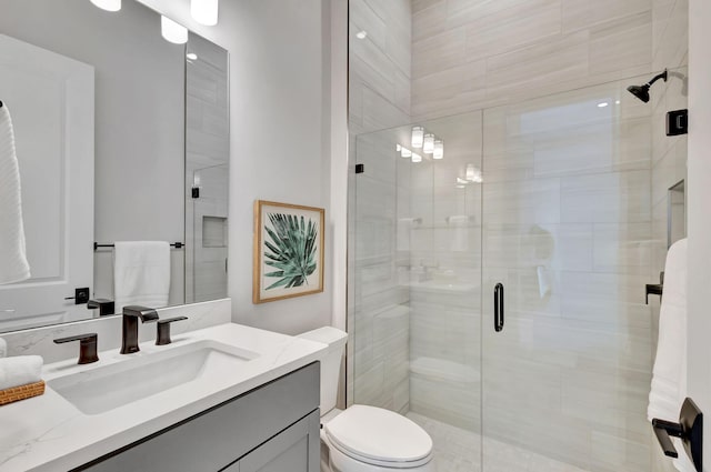 full bath featuring vanity, a stall shower, and toilet