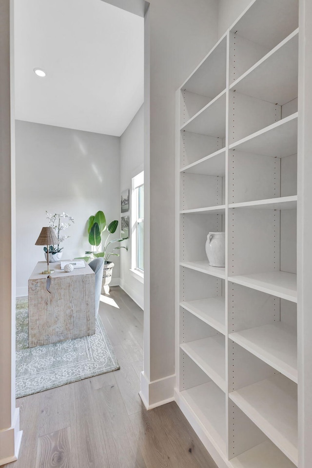 interior space with baseboards and wood finished floors