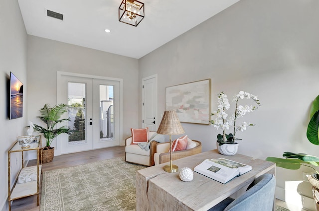 interior space featuring french doors, visible vents, wood finished floors, a notable chandelier, and recessed lighting