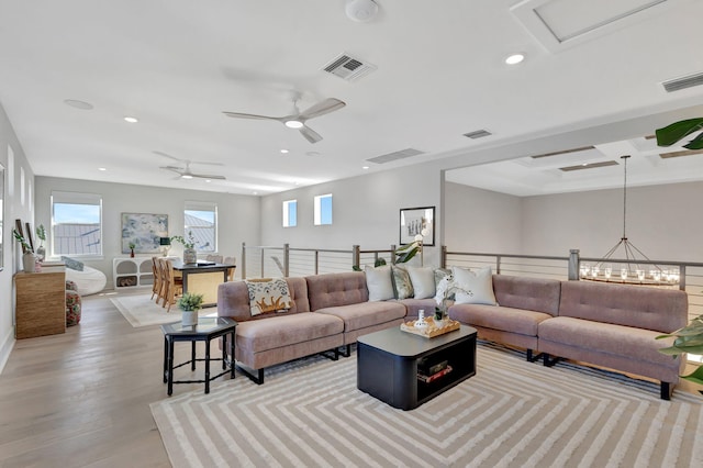 living area featuring recessed lighting, visible vents, and wood finished floors