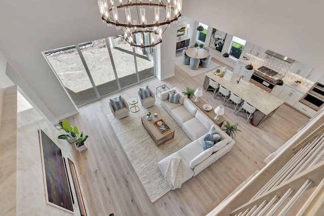 living area featuring an inviting chandelier and wood finished floors