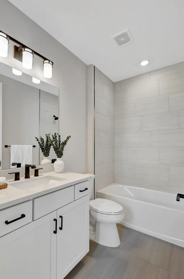 bathroom with visible vents, vanity, toilet,  shower combination, and recessed lighting