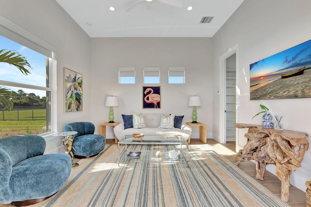living area featuring ceiling fan, visible vents, baseboards, light wood-style floors, and recessed lighting