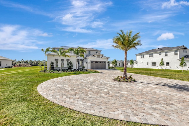 view of front of property with a residential view, a front lawn, a garage, stucco siding, and curved driveway