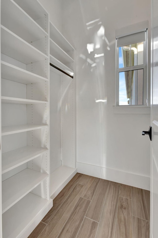 walk in closet featuring wood finished floors