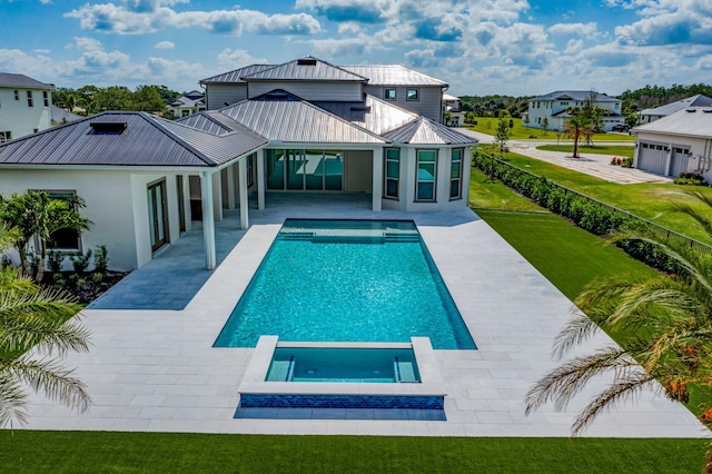back of property with a residential view, a patio area, a standing seam roof, a lawn, and metal roof
