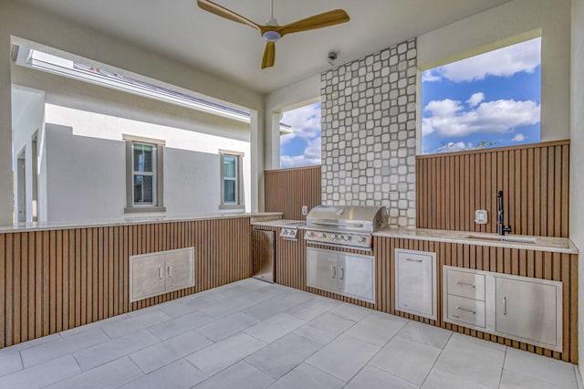 view of patio with grilling area, a sink, ceiling fan, and area for grilling