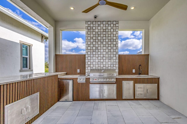 view of patio featuring grilling area, an outdoor kitchen, ceiling fan, and a sink