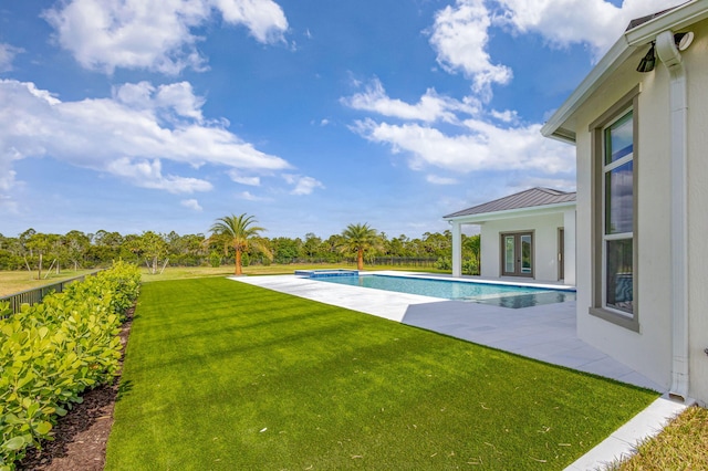 view of pool featuring a yard, a fenced in pool, french doors, and a patio area