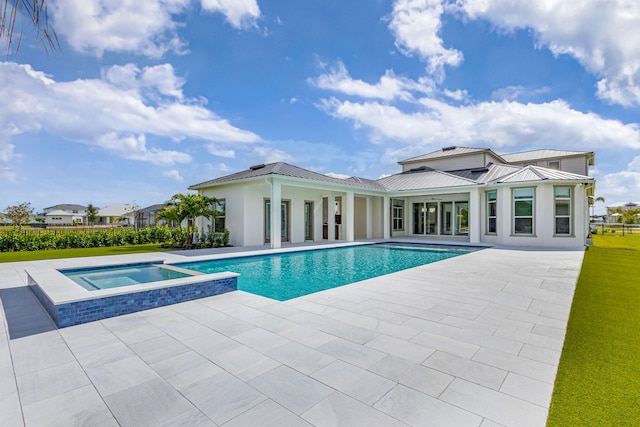 view of pool featuring a patio area and a pool with connected hot tub
