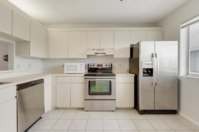 kitchen with light countertops, appliances with stainless steel finishes, white cabinets, and under cabinet range hood