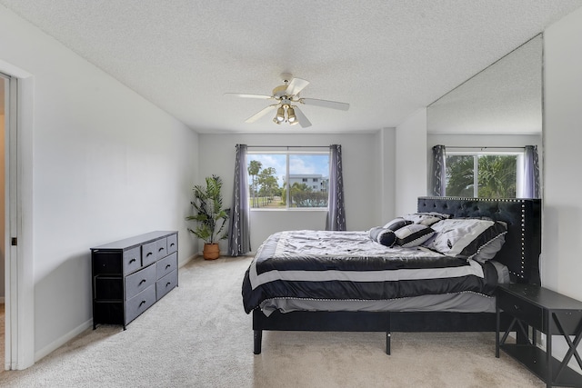 bedroom with baseboards, a ceiling fan, carpet, and multiple windows