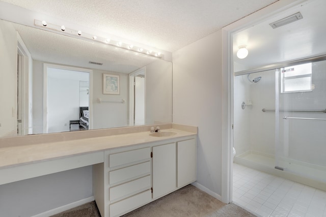 full bathroom featuring visible vents, vanity, toilet, baseboards, and a shower stall