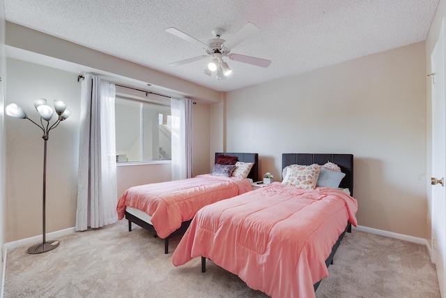 carpeted bedroom with baseboards, a textured ceiling, and a ceiling fan