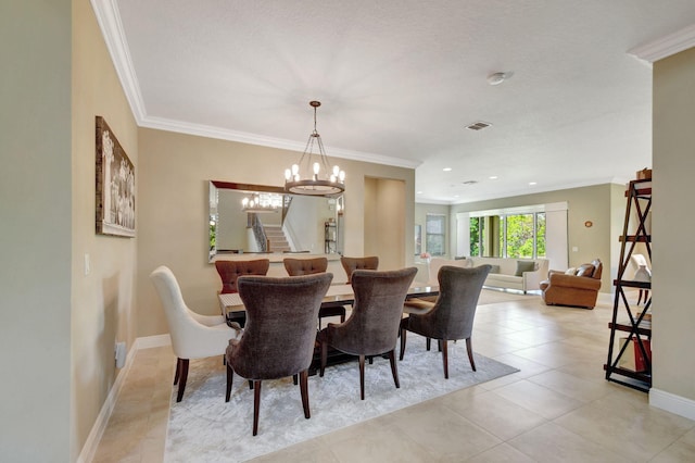 dining area with crown molding, baseboards, a chandelier, and visible vents