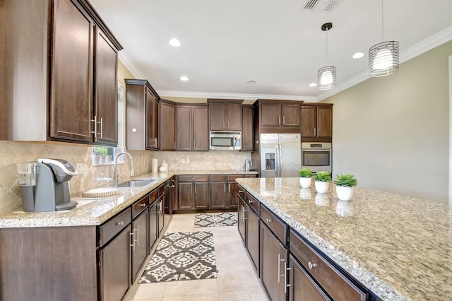kitchen featuring a sink, light stone counters, dark brown cabinetry, and stainless steel appliances
