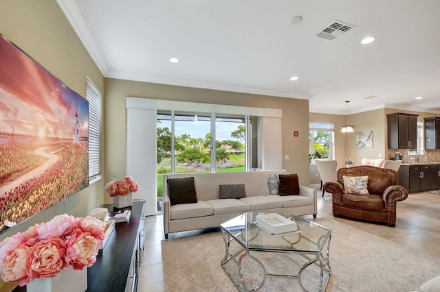 living room featuring light tile patterned floors, ornamental molding, and recessed lighting
