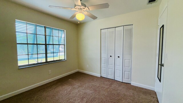 1942 SE Carvalho St, Port Saint Lucie, FL 34983 - unfurnished bedroom featuring visible vents, carpet floors, a closet, baseboards, and ceiling fan