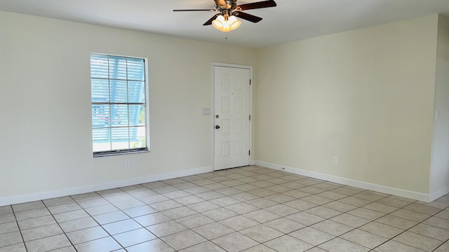 1942 SE Carvalho St, Port Saint Lucie, FL 34983 - empty room with light tile patterned flooring, ceiling fan, and baseboards