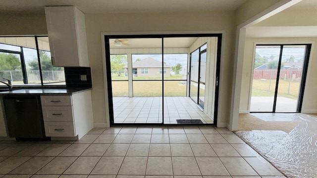 1942 SE Carvalho St, Port Saint Lucie, FL 34983 - doorway with light tile patterned floors, ceiling fan, and a healthy amount of sunlight