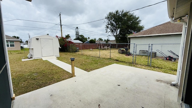 1942 SE Carvalho St, Port Saint Lucie, FL 34983 - exterior space featuring fence, a shed, a gate, an outbuilding, and a patio