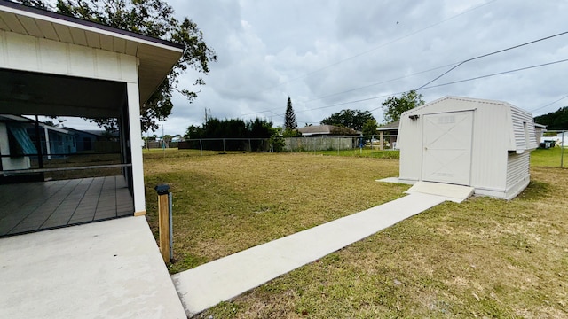 1942 SE Carvalho St, Port Saint Lucie, FL 34983 - view of yard featuring a storage shed, fence, and an outbuilding