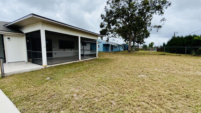1942 SE Carvalho St, Port Saint Lucie, FL 34983 - view of yard featuring fence and a sunroom