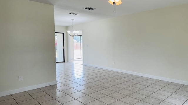 1942 SE Carvalho St, Port Saint Lucie, FL 34983 - empty room with light tile patterned flooring, baseboards, visible vents, and ceiling fan with notable chandelier