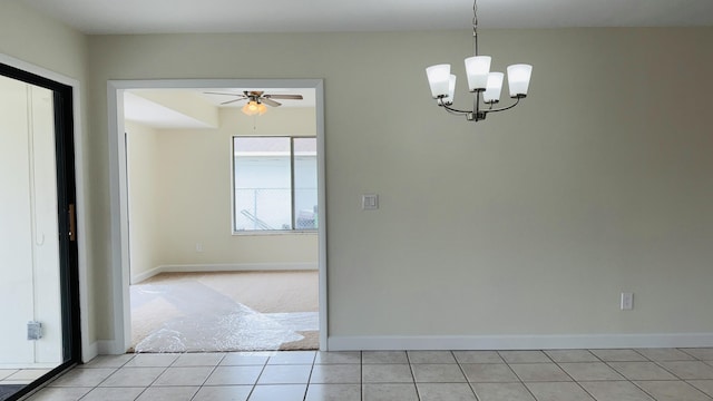 1942 SE Carvalho St, Port Saint Lucie, FL 34983 - interior space featuring baseboards, light carpet, light tile patterned floors, and ceiling fan with notable chandelier