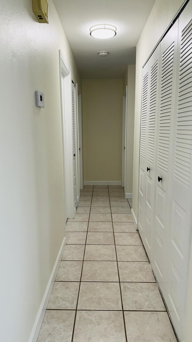 1942 SE Carvalho St, Port Saint Lucie, FL 34983 - hall featuring light tile patterned floors and baseboards