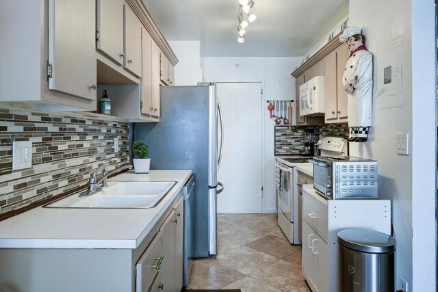 3800 Washington Rd Unit 1002, West Palm Beach, FL 33405 - kitchen featuring white appliances, tasteful backsplash, a sink, light countertops, and gray cabinets