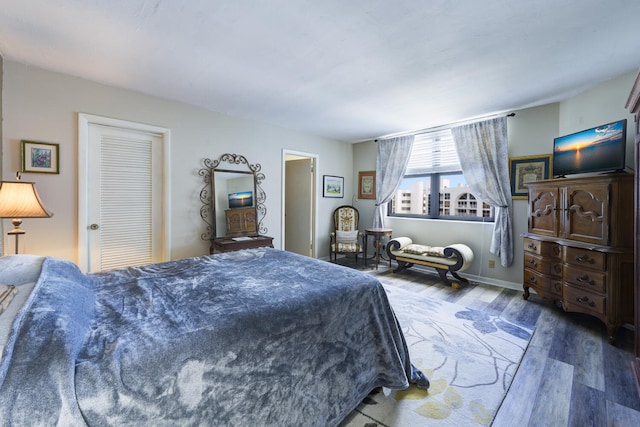 3800 Washington Rd Unit 1002, West Palm Beach, FL 33405 - bedroom with wood finished floors and baseboards