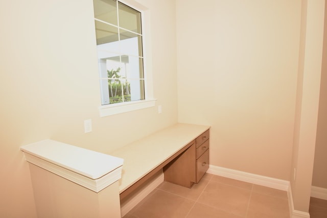 12546 Triumph Ln, Palm Beach Gardens, FL 33412 - mudroom with built in study area, baseboards, and light tile patterned floors