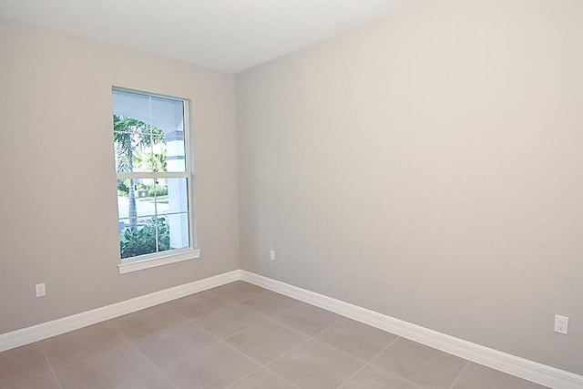 12546 Triumph Ln, Palm Beach Gardens, FL 33412 - unfurnished room with baseboards and tile patterned flooring