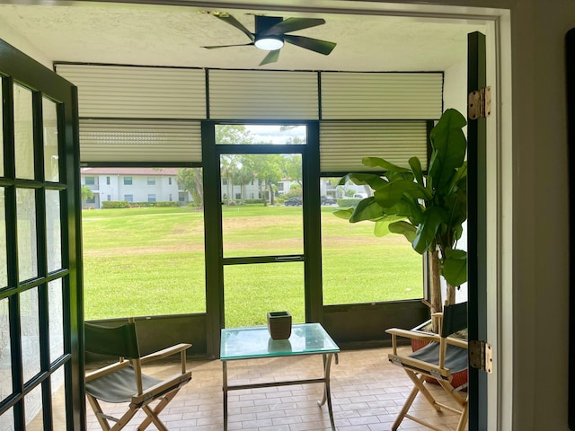 sunroom featuring ceiling fan