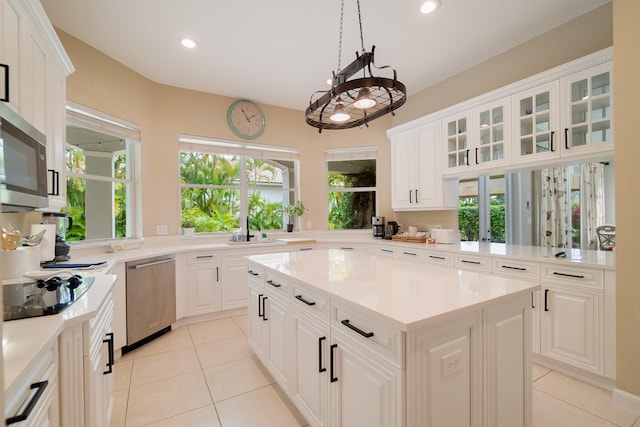 4510 Island Reef Dr, Wellington, FL 33449 - kitchen featuring a kitchen island, stainless steel appliances, light tile patterned flooring, and light countertops