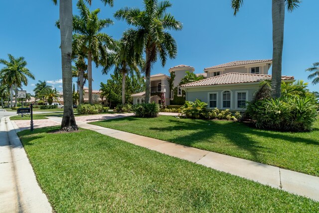 4510 Island Reef Dr, Wellington, FL 33449 - view of front of home with a front lawn, stucco siding, and a tiled roof