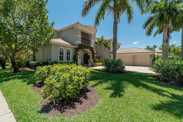 4510 Island Reef Dr, Wellington, FL 33449 - mediterranean / spanish-style house featuring a front lawn, stucco siding, an attached garage, driveway, and a tile roof