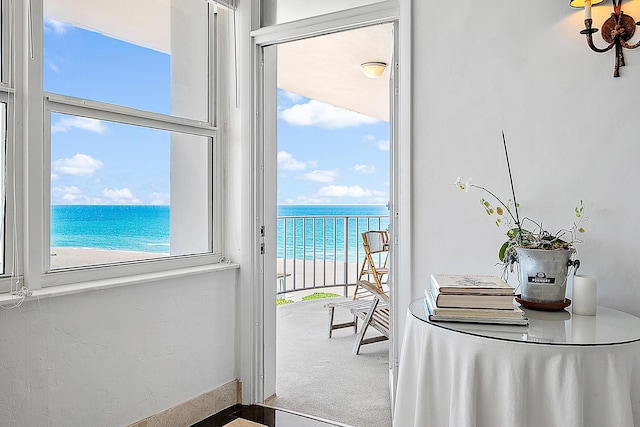 2295 S Ocean Blvd Unit 921, Palm Beach, FL 33480 - entryway featuring view of water and beach, carpet flooring, and baseboards