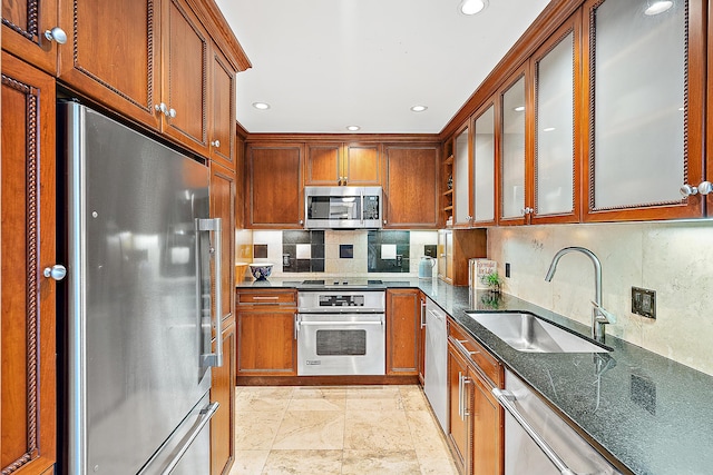 2295 S Ocean Blvd Unit 921, Palm Beach, FL 33480 - kitchen with stainless steel appliances, a sink, backsplash, recessed lighting, and glass insert cabinets