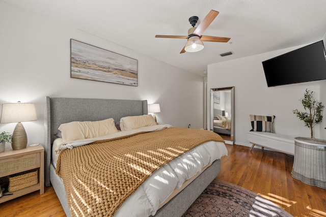 bedroom with wood finished floors and a ceiling fan